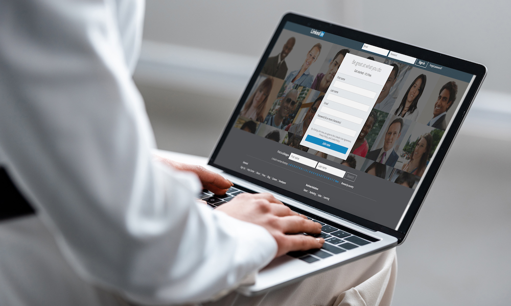 man on laptop using Linkedin
