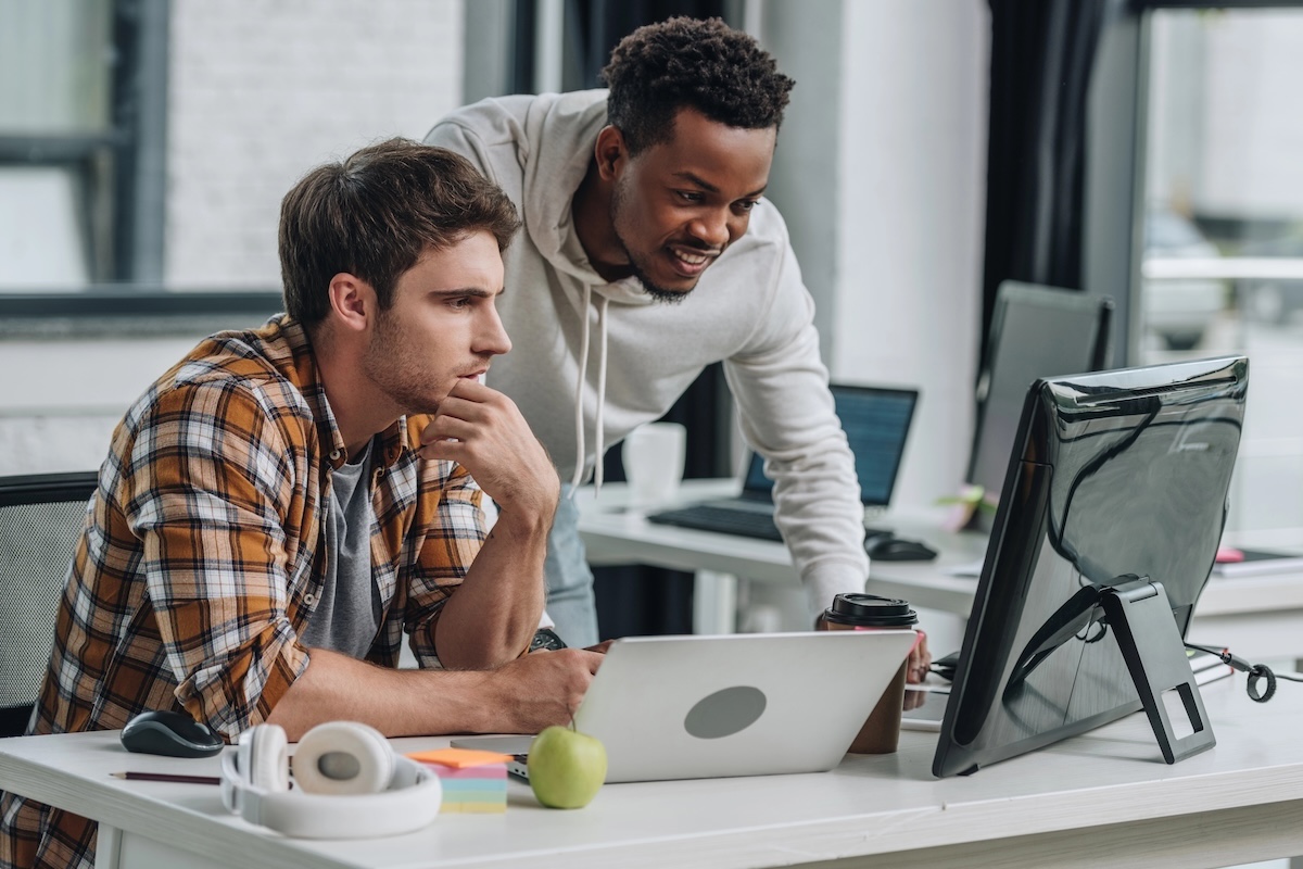 IT workers looking at a computer screen