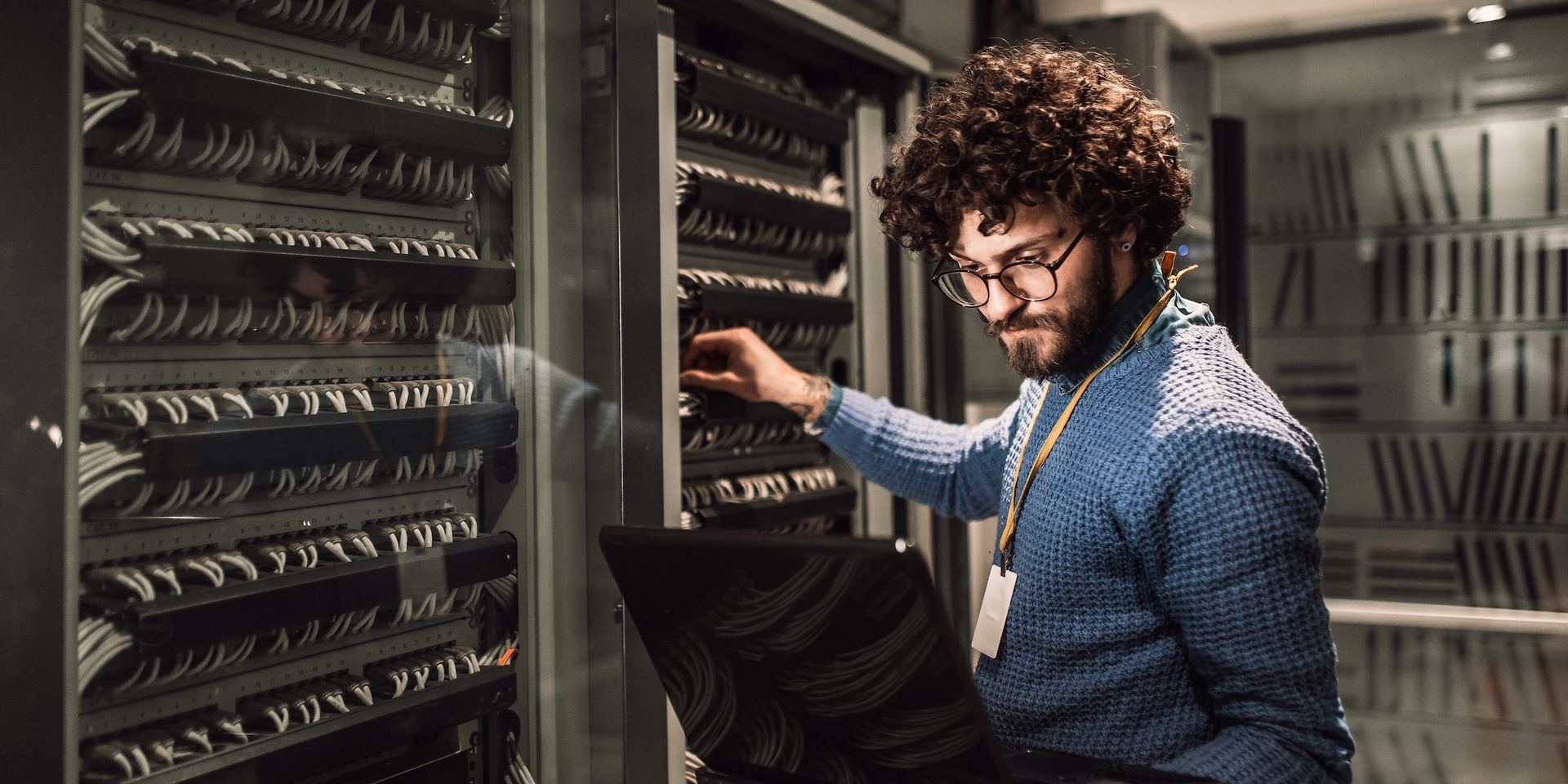 Worker in a telecoms data centre